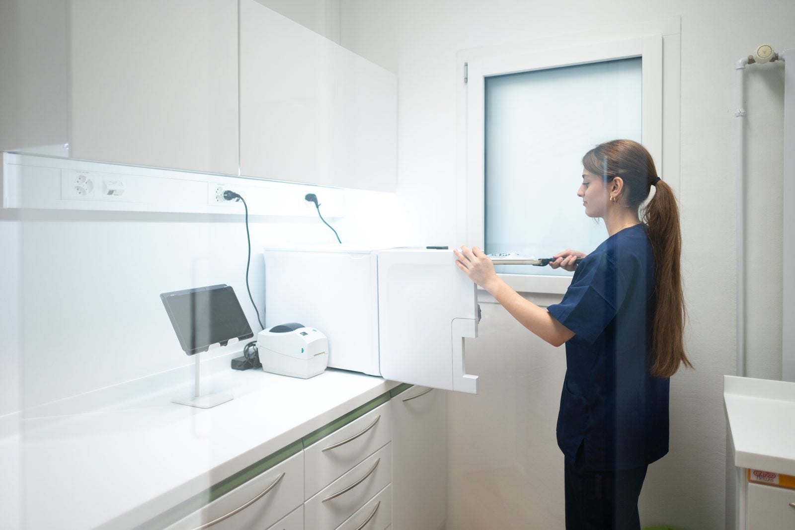 Mitarbeiterin bedient das Sterilisationsgerät